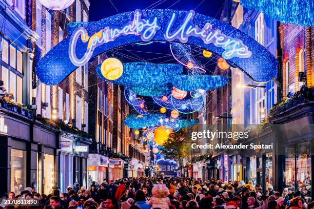 carnaby street in soho shopping district decorated for christmas holidays, london, uk - carnaby street stock pictures, royalty-free photos & images