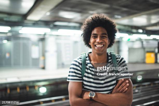 afro man on the underground waiting the train - afro comb stock pictures, royalty-free photos & images