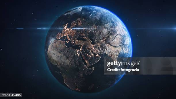 planet earth with lens flare seen from space. view of city lights at night in europe. - satellite view of earth stock pictures, royalty-free photos & images