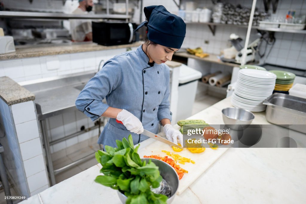 Chef chopping vegetables in a commercial kitchen