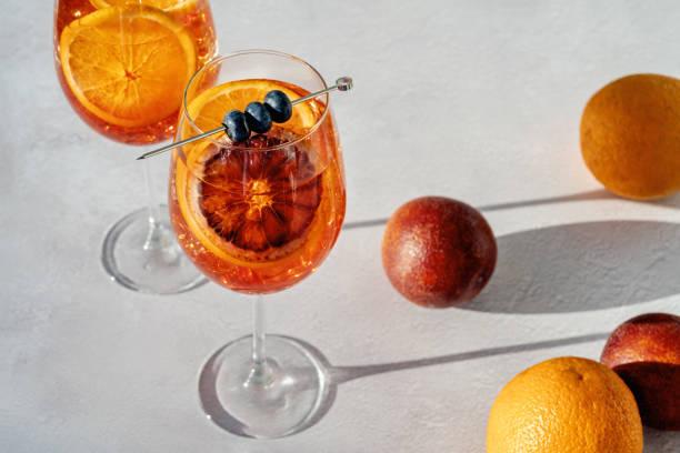cocktail or mocktail, two glasses with orange garnish, spritz - orange cocktail stock pictures, royalty-free photos & images
