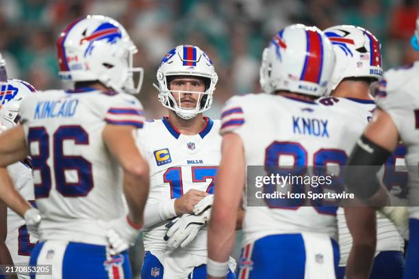 Buffalo Bills quarterback Josh Allen waits for a timeout to end in the huddle during the game between the Buffalo Bills and the Miami Dolphins on...