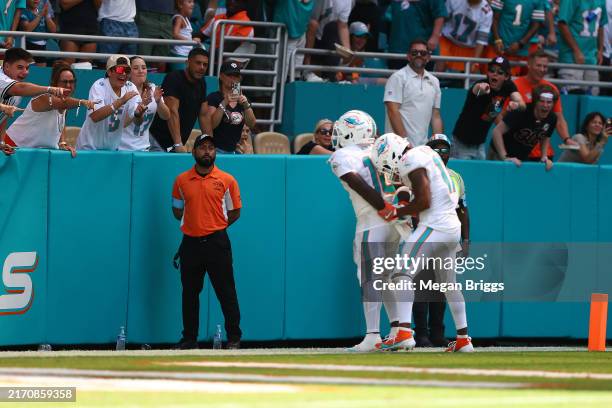 Tyreek Hill of the Miami Dolphins and Jaylen Waddle of the Miami Dolphins celebrate after Hill's receiving touchdown during the third quarter against...