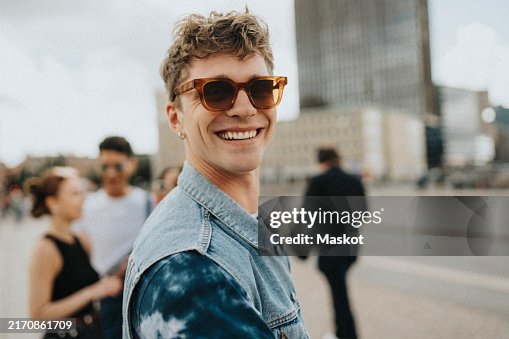 Portrait of smiling young man in sunglasses at street Portrait of smiling young man in sunglasses at street