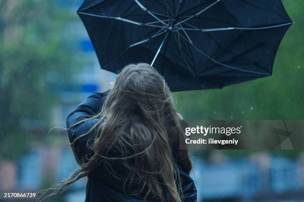 woman under umbrella. rainy weather - inside out stock pictures, royalty-free photos & images