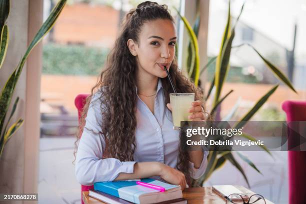 beautiful woman drinking lemonade with a straw - juice bar stock pictures, royalty-free photos & images