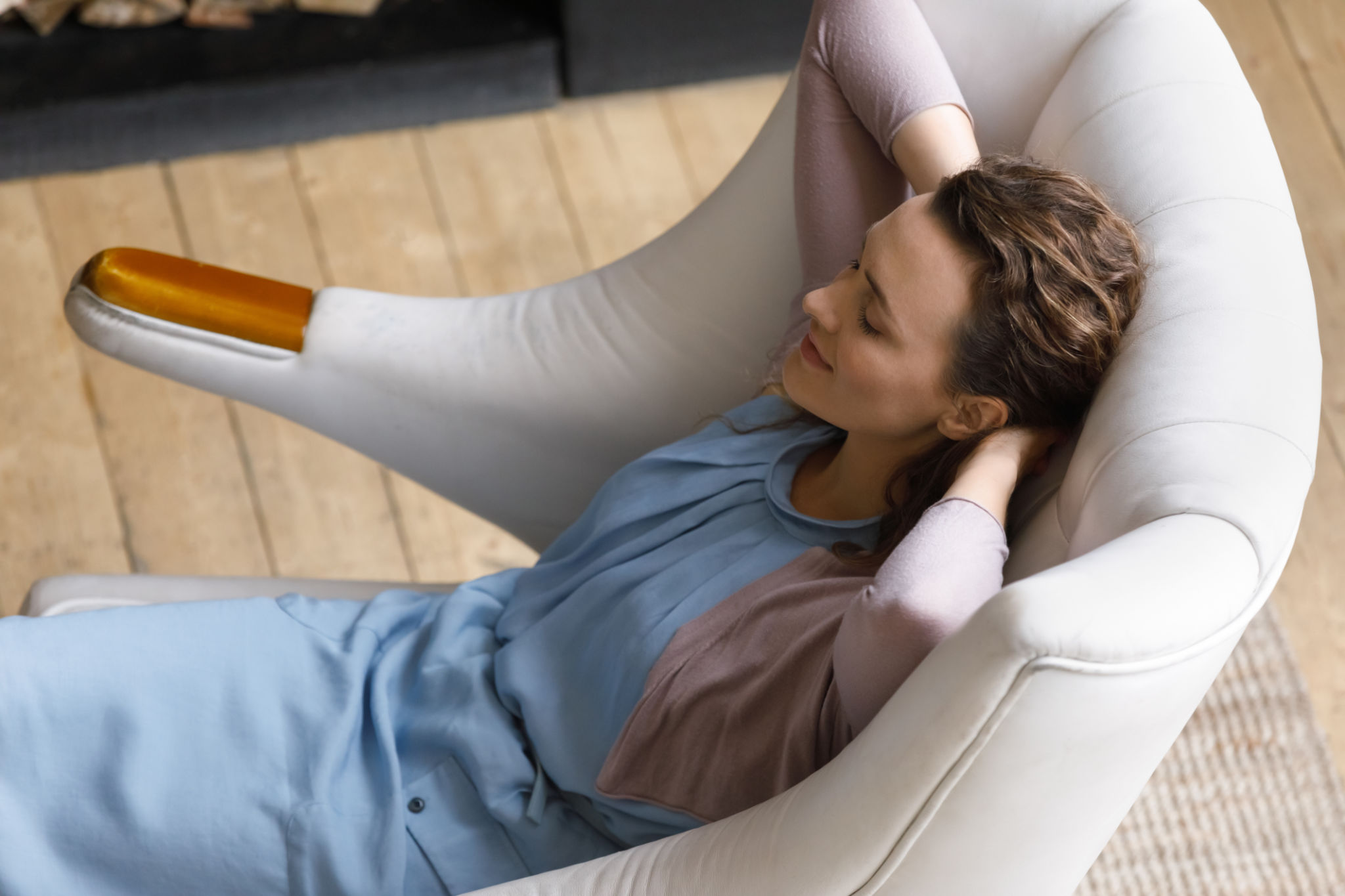 Peaceful satisfied relaxed millennial renter woman resting in soft armchair Peaceful satisfied relaxed millennial renter woman resting in soft armchair