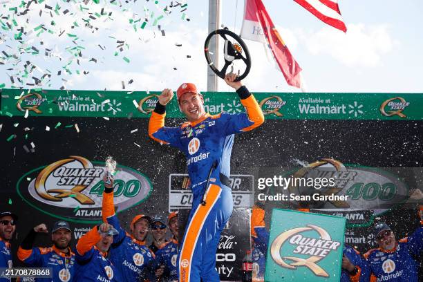 Joey Logano, driver of the Autotrader Ford, celebrates in victory lane after winning the NASCAR Cup Series Quaker State 400 Available at Walmart at...