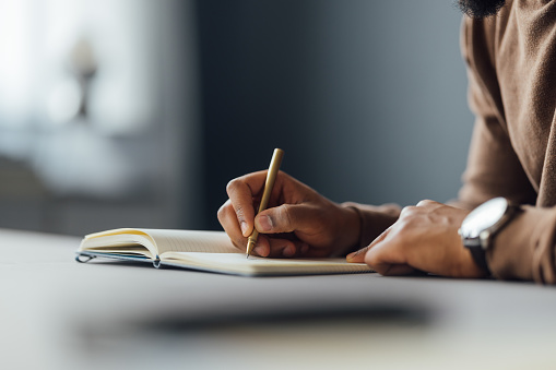 Shane Writing Closeup Of Man Writing In A Notebook At A Desk High-Res Stock Photo ...