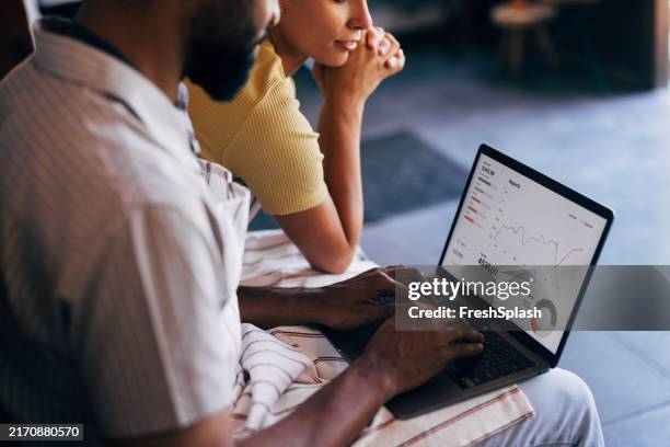 colleagues analyzing business data on a laptop computer - aspirations stock pictures, royalty-free photos & images