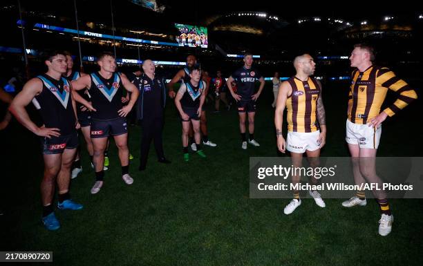 Ken Hinkley, Senior Coach of the Power exchanges words with Hawthorn players during the 2024 AFL Second Semi Final match between the Port Adelaide...