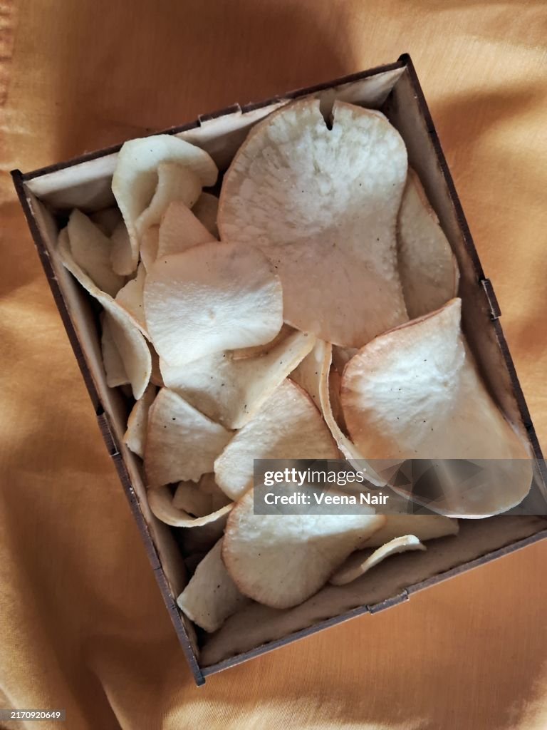 Kerala tapioca chips in a wooden box /brown background