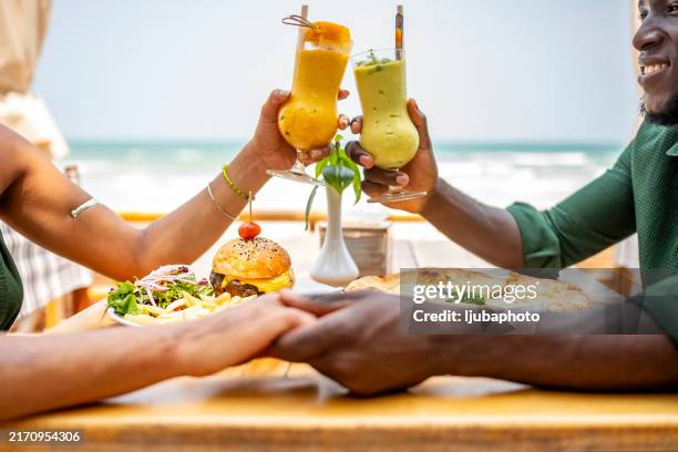romantic beachside meal with refreshing drinks and delicious food - outdoor dining stock pictures, royalty-free photos & images