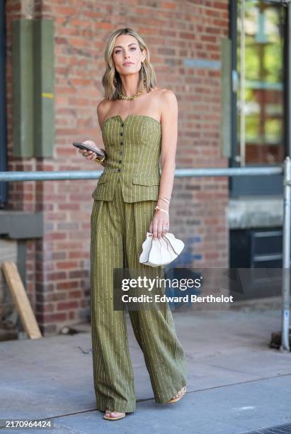 Guest wears dark green aspen Ulla Johnson Noemie textured stripe strapless wool blend tailored top, Ulla Johnson Noemie textured stripe high waisted...
