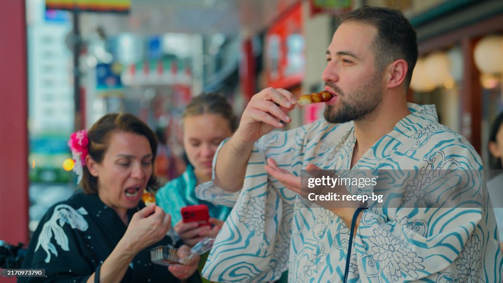 Tourist friends enjoying Japanese local street food