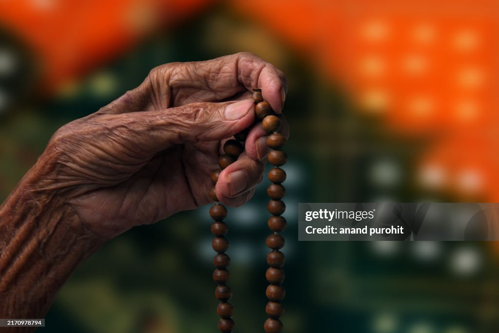 Hand Praying with Chanting Beads
