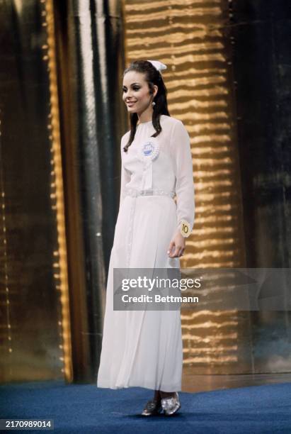 Miss Colombia, Beatriz Gonzalez, pictured in a white dress during the evening wear parade of the Miss World pageant at the Lyceum Ballroom in London,...
