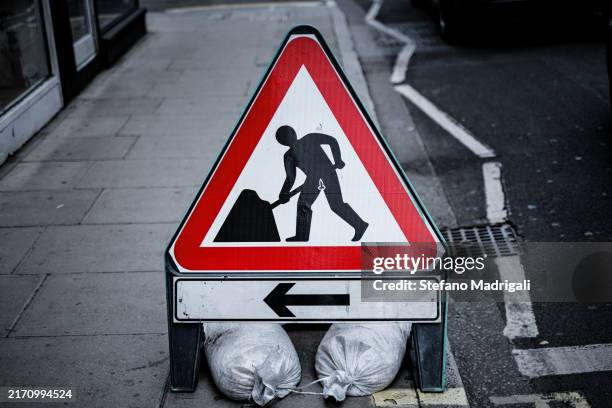 road sign work in progress, via - work in progress sign stock pictures, royalty-free photos & images