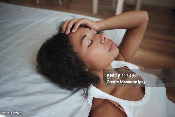 mental burnout. sad frustrated african american woman touching forehead suffering from headache or migraine, keeping eyes closed feeling depressed - trött bildbanksfoton och bilder
