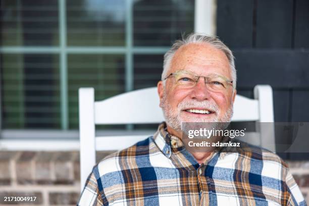 portrait of a handsome senior man at home - medicare stock pictures, royalty-free photos & images