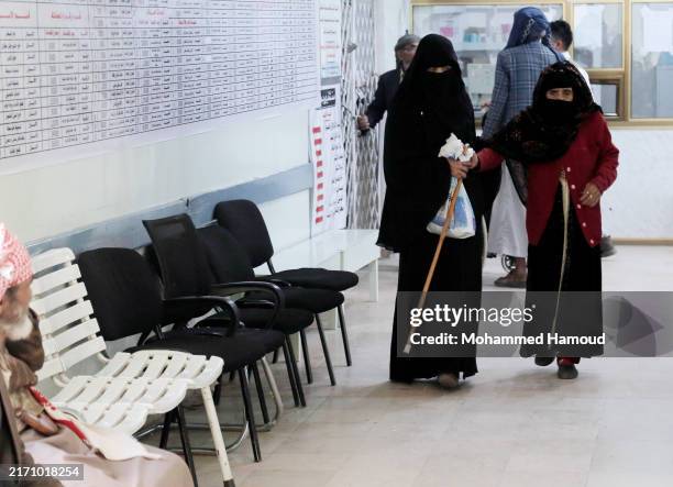 Yemeni daughter helps her mother infected with sight illnesses for medical examination, treatment, medicines, or surgeries provided by the Nebras...