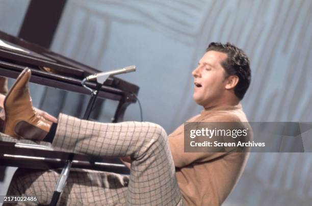 Jerry Lee Lewis playing piano with his feet from episode of 'This is Tom Jones' tv series 1969.
