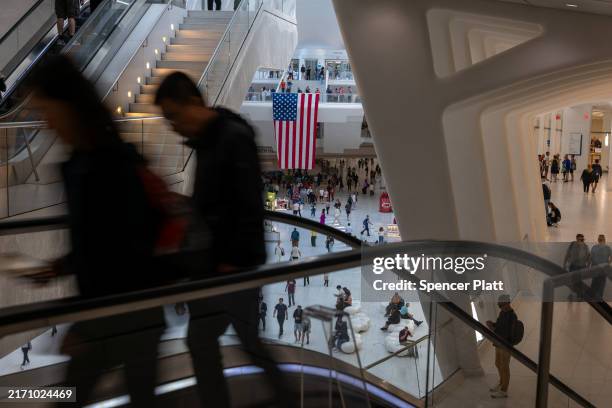 People walk through the Westfield World Trade Center shopping mall at the World Trade Center complex, which is located on the land where the Twin...