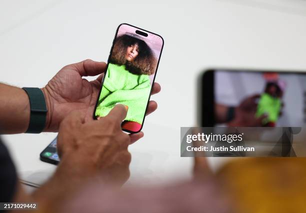 Attendees inspect the new iPhone 16 Pro and 16 Pro Max during an Apple special event at Apple headquarters on September 09, 2024 in Cupertino,...