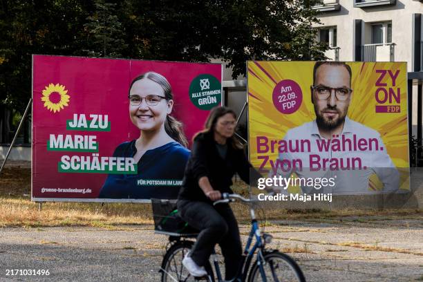 An election campaign billboard of the German Greens Party that shows candidate Marie Schäffer and the business-oriented FDP political party with...