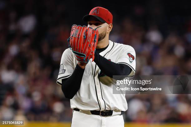 Arizona Diamondbacks pitcher Eduardo Rodriguez looks over his glove during the MLB baseball game between the Milwaukee Brewers and the Arizona...