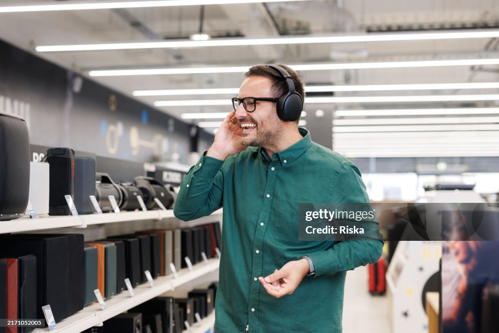 An excited music enthusiast enjoying music on wireless headphones