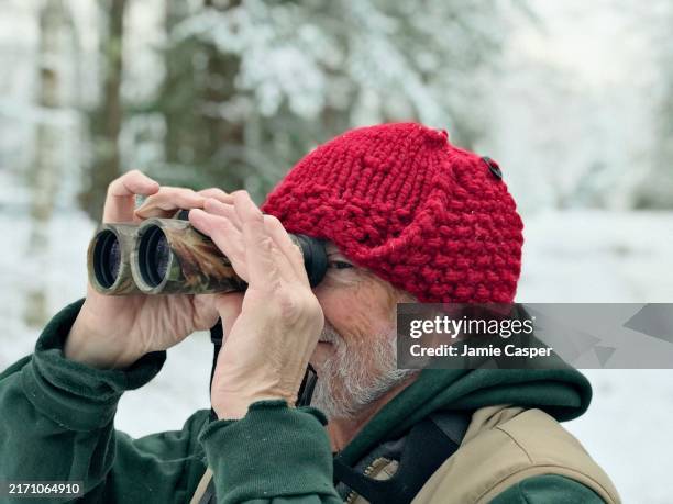 senior outdoorsman on a winter adventure. - visual snow stock pictures, royalty-free photos & images