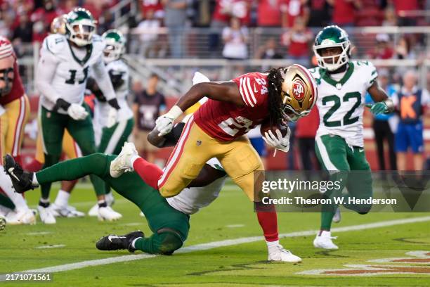 Running back Jordan Mason of the San Francisco 49ers scores a touchdown on a five-yard rush against the New York Jets during the third quarter at...
