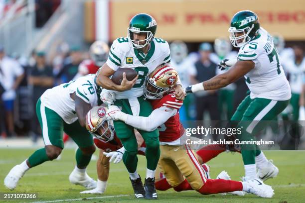 Quarterback Aaron Rodgers of the New York Jets is sacked by defensive end Leonard Floyd of the San Francisco 49ers during the second quarter at...