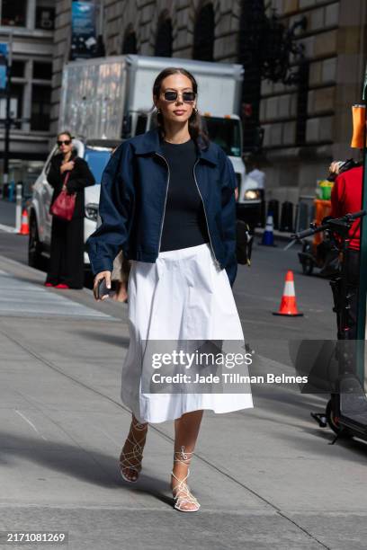 Guest is seen wearing a blue jacket, blue top, white skirt and white sandal outside the Carolina Herrera show during New York Fashion Week on...
