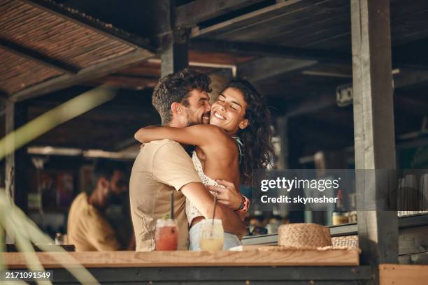 happy couple enjoying in a hug at bar. - casal-de-verdade imagens e fotografias de stock