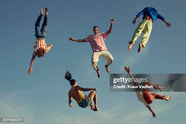multiracial friends falling from sky - levitation bildbanksfoton och bilder