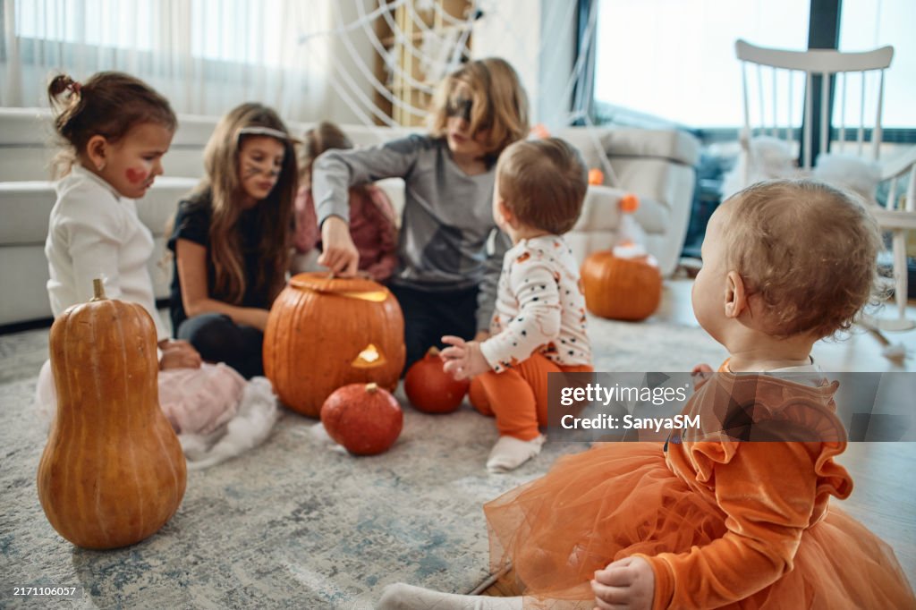 A group of children playing hocus pocus on a Halloween day