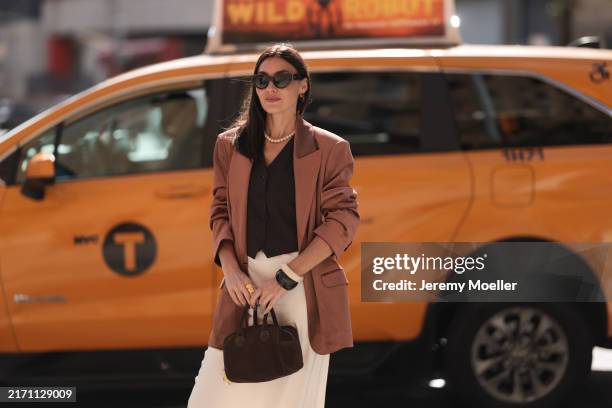 Yana Echko seen wearing YSL brown sunglasses, Bottega Veneta brown leather earrings, white pearl necklace, The Frankie Shop brown pinstripe vest,...