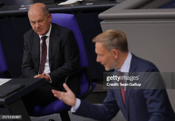 German Chancellor Olaf Scholz looks on as Finance Minister Christian Lindner speaks during debates over the 2025 federal budget at the Bundestag on...