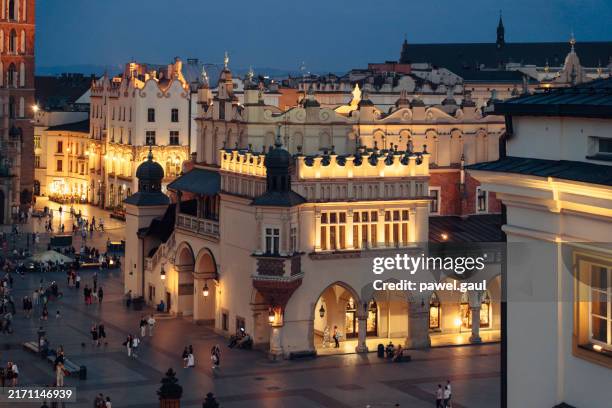 krakow cloth hall town square at night poland - krakow stock pictures, royalty-free photos & images