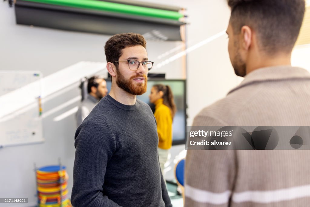 Two men talking with each other during group therapy session