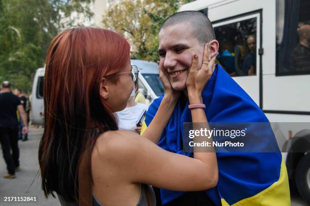 Relative hugs a Ukrainian prisoner of war who returns from captivity as forty-nine civilian and military Ukrainians return to Ukraine after a swap...