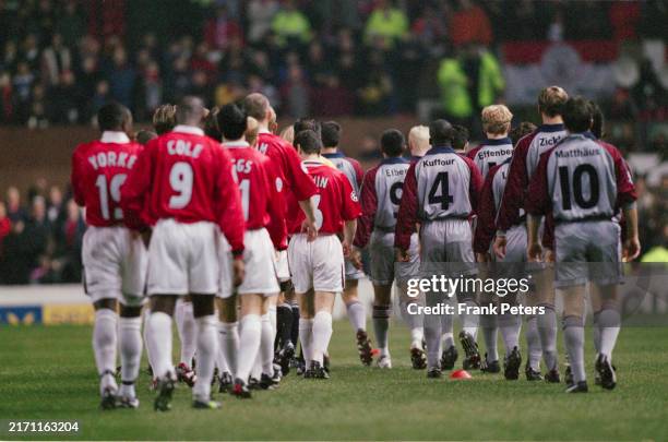 The Manchester United players and Bayern Munich players on the pitch ahead of the UEFA Champions League Group D match between Manchester United and...