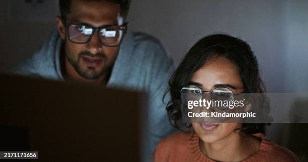 hispanic latin american couple, software engineer developer use computer, work on program coding together at home office. programming language development technology, freelance job at night concept - python coding language stock pictures, royalty-free photos & images