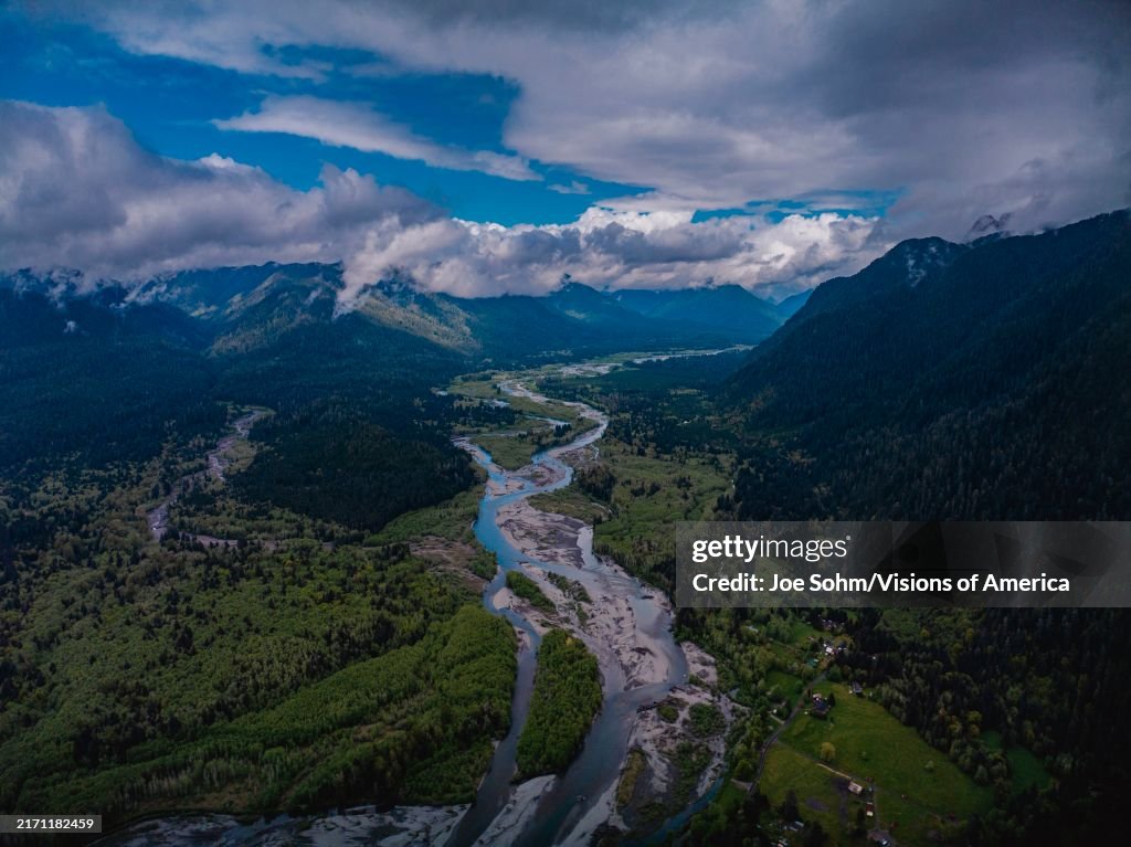 Aerial view of snow capped mountains and river leading to Olympic National Park, Washington State