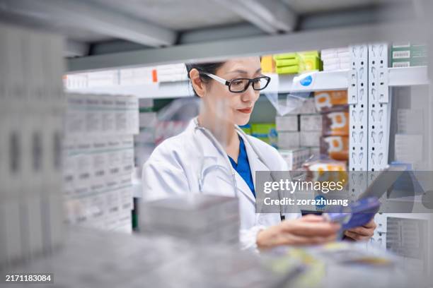 close-up of asia female pharmacist working at pharmacy - chemist stock pictures, royalty-free photos & images