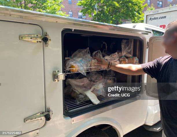 Man delivering meals on wheels, Queens, New York.