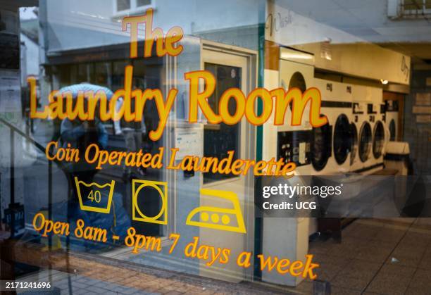 Looking through the window in to The Laundry Room, a coin operated launderette in Totnes, Devon, UK.