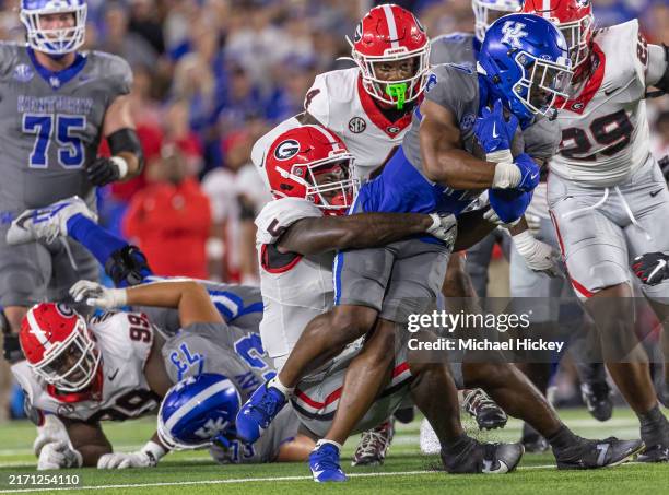 Demie Sumo-Karngbaye of the Kentucky Wildcats runs the ball as Raylen Wilson of the Georgia Bulldogs tries to make the tackle during the first half...